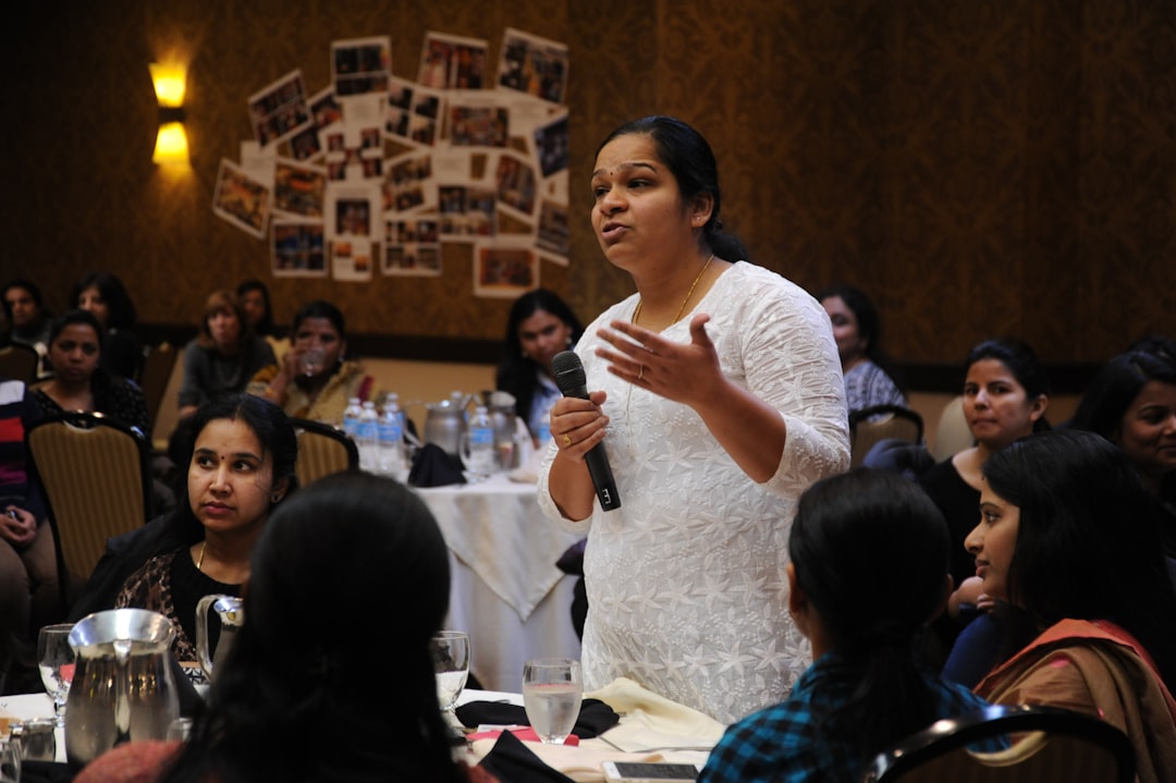 A woman advises the CEO, (out of frame), while he fields questions from the floor, A Celebration of Woman’s Day, Seattle Region, Bellevue, Washington, USA. All the women shown work in high tech as consultants in the US. They are the best and brightest from universities in India. They remain concerned about children in general but specifically girls in India and the rest of the developing world and aspire to help them. A sub-section of technology workers, many of these women are in the US on H1-B Visas.

drop a penny if you wish https://paypal.me/1drlane
wonderlane@gmail.com